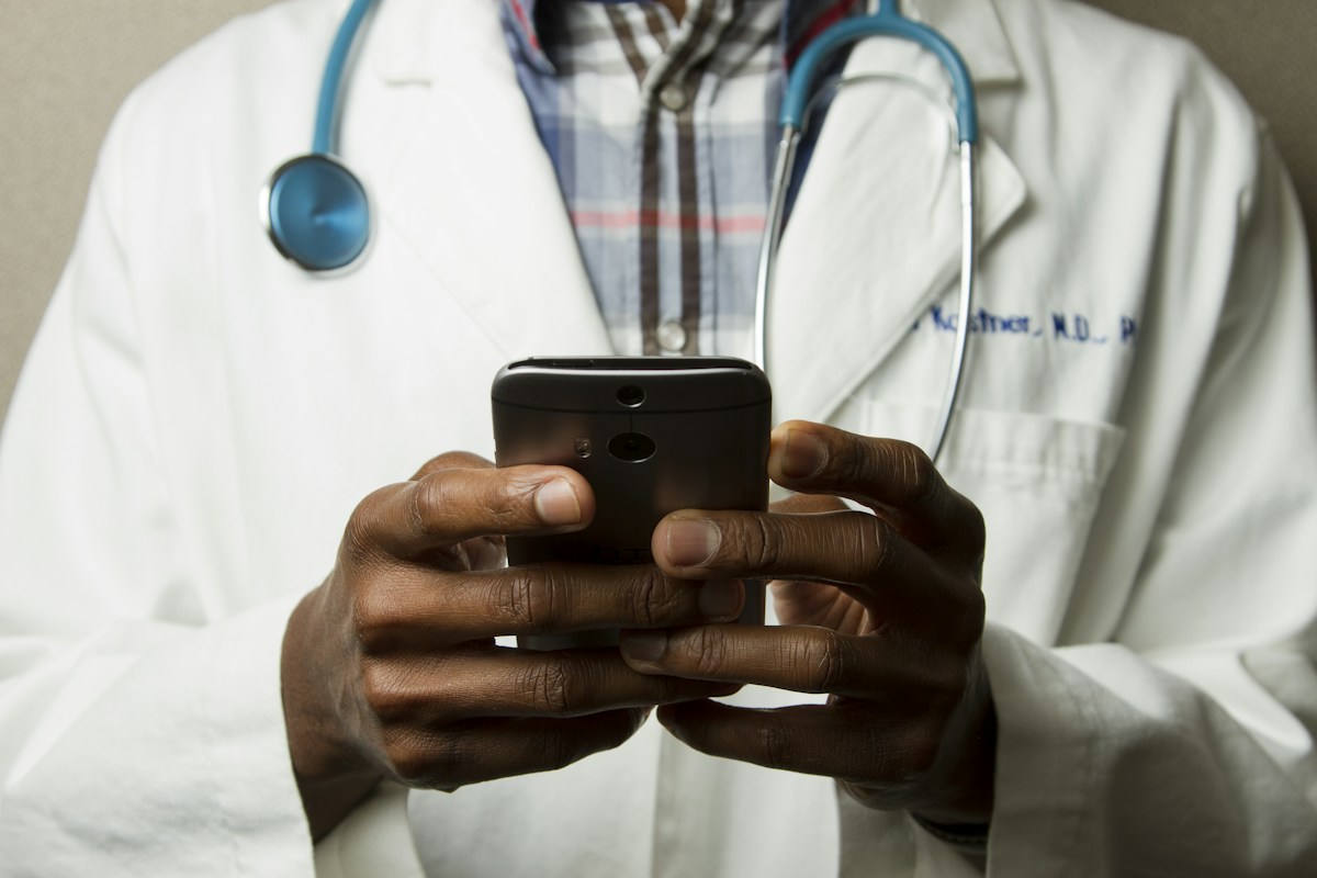 Clinician using a phone to coordinate information