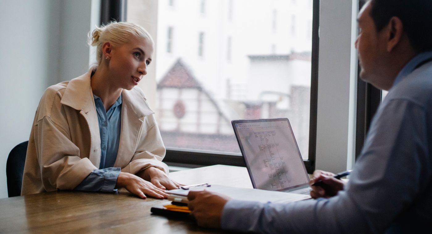 Two people coordinating written documents