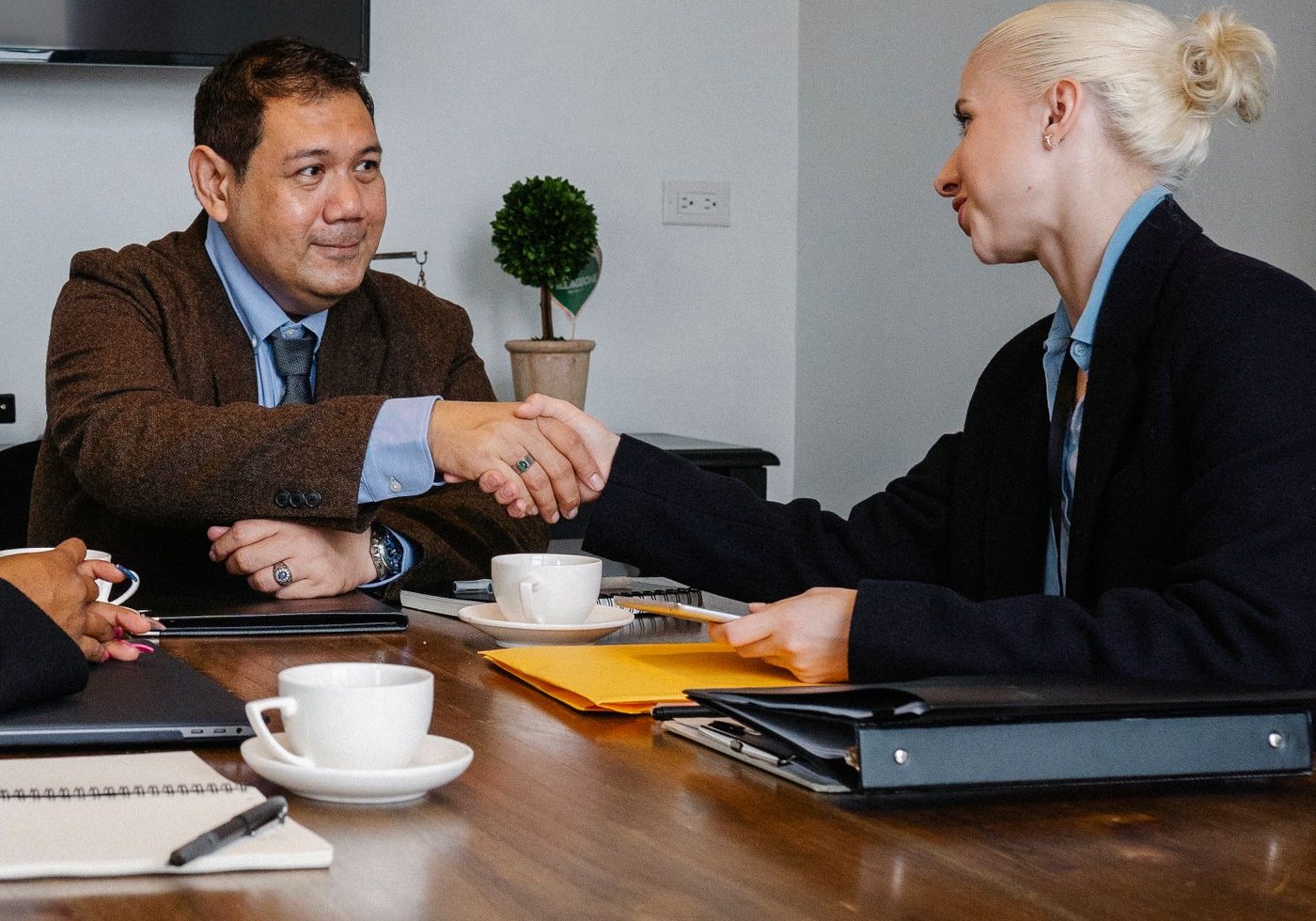 Two people meeting across a desk